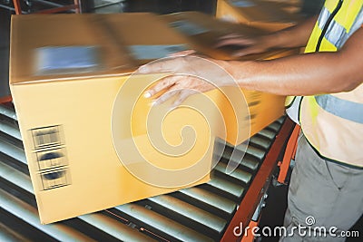 Worker Sorting Packaging Boxes on Conveyor Belt. Cartons, Cardboard Boxes. Storehouse. Distribution Warehouse. Shipping Supplies Stock Photo