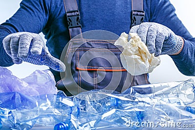Worker sorting plastic garbage for recycling. Process plastic polymers sorting. Ecology Stock Photo