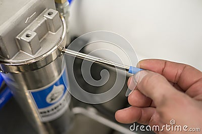 Worker tighten industrial water filter by hand Stock Photo