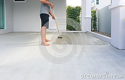 Worker to skim coat surface of concrete pavement floor or slab Stock Photo