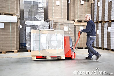 Worker Transporting Goods On Handtruck Stock Photo