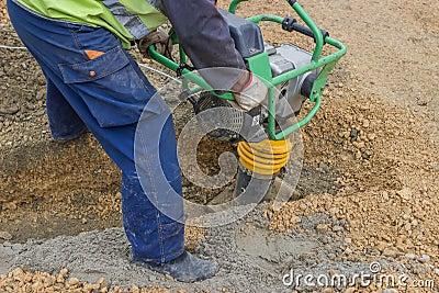 Worker with trench rammer Stock Photo