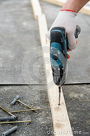 Worker twists the screw. Stock Photo
