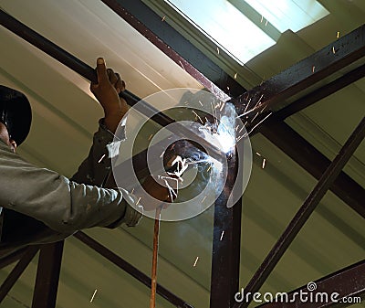 Worker us electric welding connecting construction Stock Photo