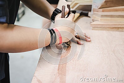 Worker use nail plier tool to remove nail from wood. Stock Photo