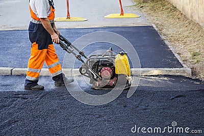 Worker use vibratory plate compactor Stock Photo