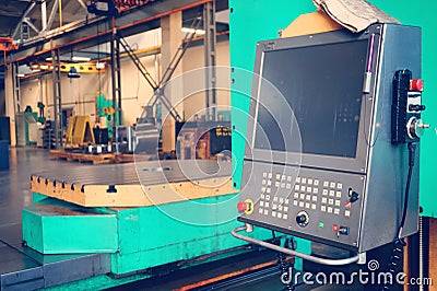 The worker uses the control panel of the CNC machine to process the material. Stock Photo