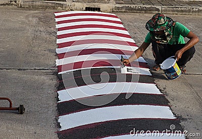 Worker using brush for painting white line on the road Editorial Stock Photo