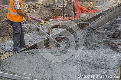 Worker using concrete vibrator Stock Photo