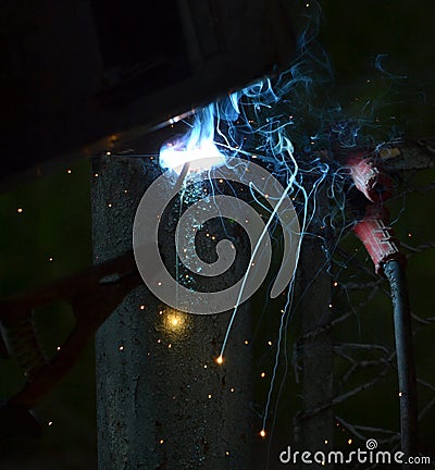 Worker using electric welding machine Stock Photo