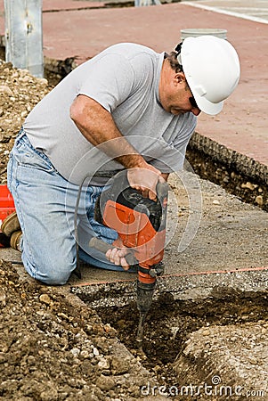 Worker using Hammer Chisel Stock Photo