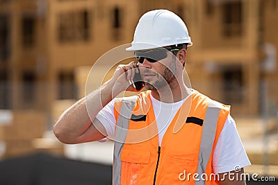 Worker using phone, builder taking on phone a break from work. Architect with mobile phone. Engineer worker in builder Stock Photo