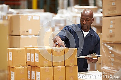 Worker In Warehouse Preparing Goods For Dispatch Stock Photo