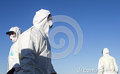 A worker wearing a protective gear unloads personal protection equipment from a plane Editorial Stock Photo