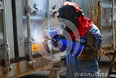 Worker welder container box maintenance Stock Photo