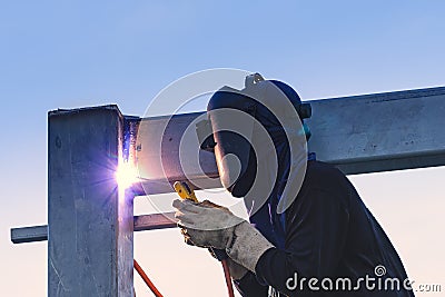 Worker welding parts of stell construction Stock Photo