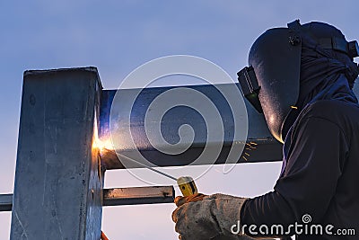Worker welding parts of stell construction Stock Photo