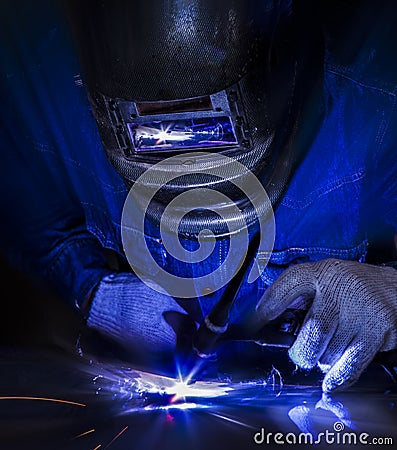 Worker welding the steel part Stock Photo