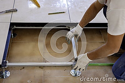 Worker who creates a floating raised floor. Stock Photo