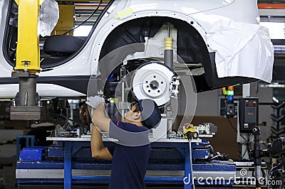 Workers assembles cars at automobile assembly line production plant Editorial Stock Photo