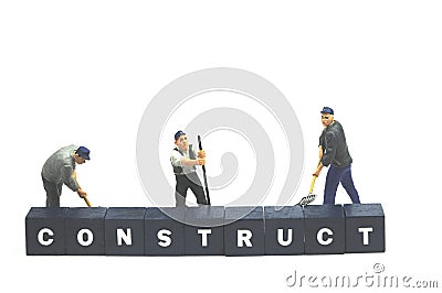 Workers behind word construct Stock Photo