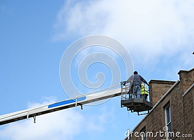 Workers in cherry picker Stock Photo