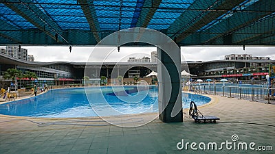 Shenzhen, China: Workers clean and prepare for the opening of a swimming pool at the sports center Editorial Stock Photo