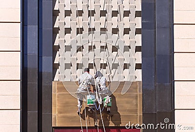 Workers cleaning front of a shopping mall, Changchun, China Editorial Stock Photo