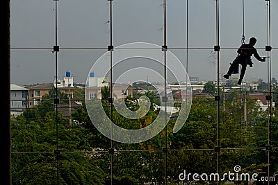 Workers cleaning windows service on high rise building Editorial Stock Photo
