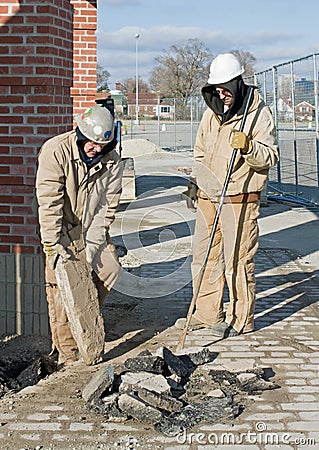 Workers Clearing Pavement Stock Photo