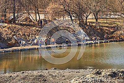 Workers clearing rivers and reconstructing coastal areas with trees Stock Photo