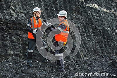 Workers with coal at open pit Stock Photo