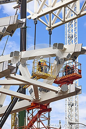 Workers on a construction site. Engineering and architectural infrastructure. Safety Stock Photo