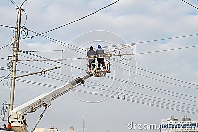 Workers on the crane install and decorate the Astrakhan bridge with led light in Volgograd Editorial Stock Photo