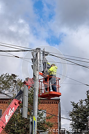 Rybinsk Russia 14.09.19 Workers on a crane using an arrow to repair a broken traffic light Editorial Stock Photo