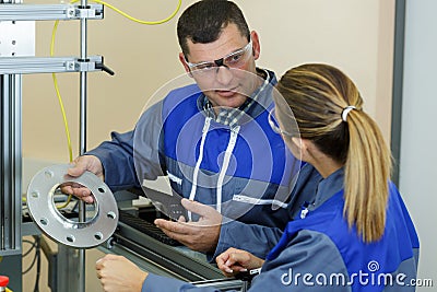 Workers discussing use disc cutter Stock Photo