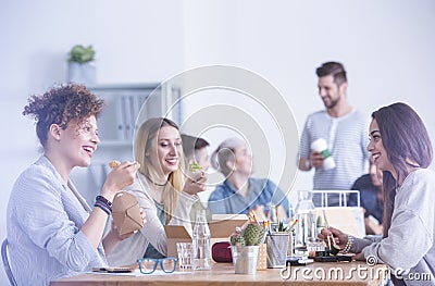 Workers eating at the office Stock Photo