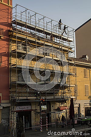 Workers engaged in assembling a scaffolding Editorial Stock Photo