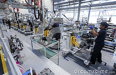 Workers at engine assembly plant Editorial Stock Photo