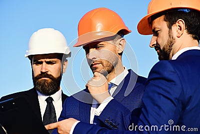 Workers and engineer hold meeting on project. Builders discuss plan Stock Photo