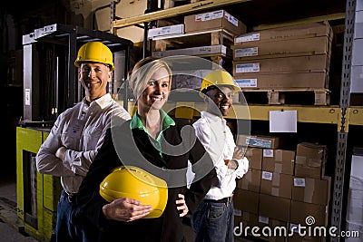 Workers with female boss in storage warehouse Stock Photo