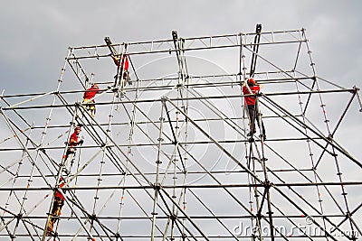 Workers fix holiday decoration on the Red Square in Moscow. Editorial Stock Photo