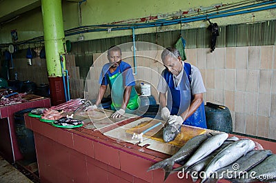 Workers handling fish on parts at fish market Editorial Stock Photo