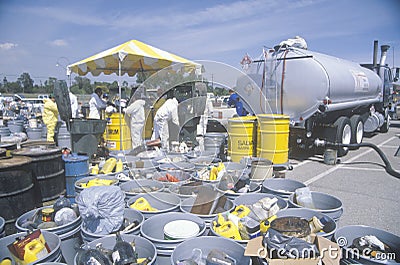 Workers handling toxic household wastes at waste cleanup site on Earth Day at the Unocal plant in Wilmington, Los Angeles, CA Editorial Stock Photo