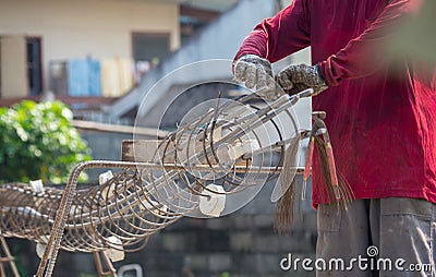 Workers hands put on gloves using hand to iron wire to tie for structure the house or building Editorial Stock Photo