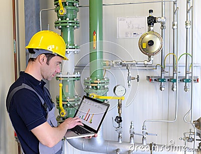 workers in an industrial plant check the systems with modern technology Stock Photo