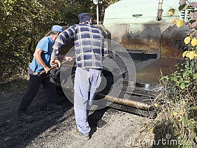 Workers laying the asphalt Editorial Stock Photo