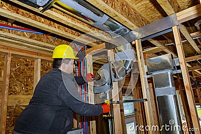 Workers making final air duct conditioning HVAC system stands for heating Editorial Stock Photo