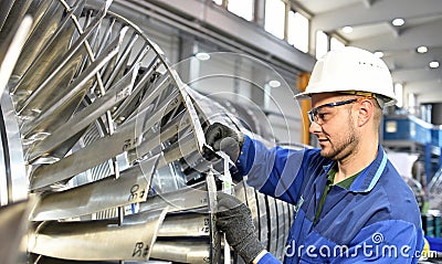 Workers manufacturing steam turbines in an industrial factory Stock Photo