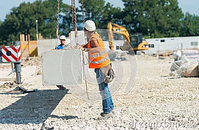 Workers operating in contruction building site Editorial Stock Photo